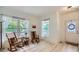 Bright sitting area with rocking chairs, a side table, and large windows with sheer curtains at 3525 Rinn Valley Dr, Longmont, CO 80504
