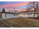 Exterior of home featuring mountain views, brick and wood fence and a small deck at 214 Iowa Dr, Golden, CO 80403