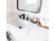 Close up on bathroom with marble counter, black faucet, and minimal decor at 214 Iowa Dr, Golden, CO 80403