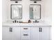 Bright bathroom with dual sinks, black hardware, and modern fixtures, set in a newly renovated home at 214 Iowa Dr, Golden, CO 80403