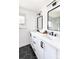 Bathroom with bright white and black finishes, double vanity, and hexagon floor tiles at 214 Iowa Dr, Golden, CO 80403