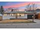 Charming single-story home with a black door, contrasting trim, and well-maintained front lawn at 214 Iowa Dr, Golden, CO 80403