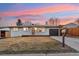 Charming single-story home featuring a clean white exterior, an attached garage, and a cozy front yard at 214 Iowa Dr, Golden, CO 80403