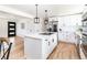 Bright kitchen featuring an island with cooktop, stainless appliances, and modern pendant lights at 214 Iowa Dr, Golden, CO 80403