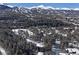 Aerial view of a snowy mountain resort community with homes and trees at 246 Broken Lance Dr # 503, Breckenridge, CO 80424