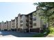 Tan multi-unit building with balconies and garages; summer scene at 246 Broken Lance Dr # 503, Breckenridge, CO 80424