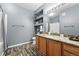 Bathroom with granite counters, ample storage, a shower/tub, and decorative shelving at 474 Black Feather Loop # 406, Castle Rock, CO 80104