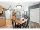 Open floor plan combining the dining room with wood floors and stylish lighting at 474 Black Feather Loop # 406, Castle Rock, CO 80104