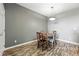 Simple dining room setup with wood floors, gray paint and light fixture at 474 Black Feather Loop # 406, Castle Rock, CO 80104