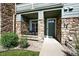 Inviting condo entrance with stone accents, showcasing a well-maintained exterior and a private front porch at 474 Black Feather Loop # 406, Castle Rock, CO 80104