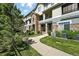 Exterior shot showcases the building's stone accents, manicured lawn, and inviting sidewalk leading to the condo units at 474 Black Feather Loop # 406, Castle Rock, CO 80104