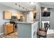The kitchen has bar seating and a decorative fireplace at 474 Black Feather Loop # 406, Castle Rock, CO 80104