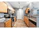 Kitchen with wooden cabinets, stainless appliances, granite countertops and wood floors at 474 Black Feather Loop # 406, Castle Rock, CO 80104