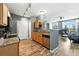 Well-lit kitchen with wooden cabinets, granite countertops, and stainless steel appliances at 474 Black Feather Loop # 406, Castle Rock, CO 80104