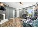 Bright living room featuring hardwood floors, a fireplace with mounted TV, and a large window with community views at 474 Black Feather Loop # 406, Castle Rock, CO 80104