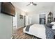 Comfortable bedroom with en suite bathroom, ceiling fan, TV, and closet space at 474 Black Feather Loop # 406, Castle Rock, CO 80104