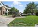 Community playground with green grass and mature trees, perfect for families with young children at 474 Black Feather Loop # 406, Castle Rock, CO 80104