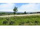 Scenic view of the surrounding landscape featuring grass, highway, mountain range in distance at 474 Black Feather Loop # 406, Castle Rock, CO 80104