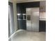 Kitchen featuring stainless steel refrigerator, black cabinets, and built-in oven at 1040 Stuart St, Denver, CO 80204