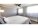 Well-lit bedroom with white curtains, plush carpet, and a ceiling fan at 1035 Colorado Blvd # 405, Denver, CO 80206