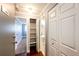 Hallway view with closet storage, nearby bathroom, and bedroom with wood flooring at 1035 Colorado Blvd # 405, Denver, CO 80206