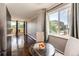 Kitchen area with black appliances, hardwood floors, a window view, and dining table at 1035 Colorado Blvd # 405, Denver, CO 80206