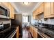 Updated kitchen featuring wood cabinets, stainless steel appliances, and granite countertops at 1035 Colorado Blvd # 405, Denver, CO 80206