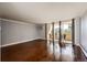 Spacious living room featuring hardwood floors, neutral paint, and access to a balcony with a view at 1035 Colorado Blvd # 405, Denver, CO 80206