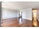 Open-concept living room with hardwood floors, gray walls, and connecting hallway to kitchen at 1035 Colorado Blvd # 405, Denver, CO 80206