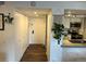 Inviting entryway featuring wood-look floors, coat closet and partial view of the kitchen with concrete countertop at 13962 E Stanford Cir # L07, Aurora, CO 80015