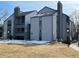 Multi-story condominium complex featuring a blue-gray exterior and chimney on a sunny day at 13962 E Stanford Cir # L07, Aurora, CO 80015