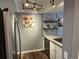 Cozy kitchen with stainless steel appliances, white cabinets, concrete countertop and decorative shelving at 13962 E Stanford Cir # L07, Aurora, CO 80015