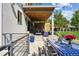 Beautiful backyard featuring covered patio, dining area, lush lawn, and swing set at 2658 Wolff St, Denver, CO 80212
