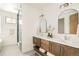 Bright bathroom with double vanities, modern fixtures, and a luxurious glass-enclosed shower at 2658 Wolff St, Denver, CO 80212