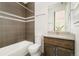 Modern bathroom with a combination tub/shower and updated vanity at 2658 Wolff St, Denver, CO 80212