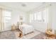 Cozy bedroom featuring a comfortable bed, carpet, and bright natural light at 2658 Wolff St, Denver, CO 80212