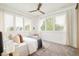 Bright bedroom with large windows, plantation shutters, and a ceiling fan at 2658 Wolff St, Denver, CO 80212