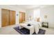 Bright bedroom with neutral tones, large closet, and comfortable furnishings at 2658 Wolff St, Denver, CO 80212