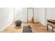 Bright bonus room with yoga mat, oversized mirror, and hardwood floors at 2658 Wolff St, Denver, CO 80212