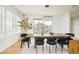 Bright dining area featuring a large window, decorative chandelier, and modern furniture at 2658 Wolff St, Denver, CO 80212