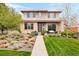 Charming two-story home featuring a well-manicured lawn and inviting front porch at 2658 Wolff St, Denver, CO 80212