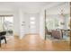 Bright, airy foyer with wood floors, minimalist decor, and a glimpse into a home office at 2658 Wolff St, Denver, CO 80212