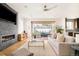 Relaxing living room showcasing a modern fireplace, ceiling fan, and sliding glass doors to backyard at 2658 Wolff St, Denver, CO 80212