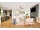 Open-concept living space with views of the kitchen and staircase, featuring a modern fireplace at 2658 Wolff St, Denver, CO 80212