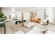 Open living area with cozy seating, neutral decor, and adjacent dining space at 2658 Wolff St, Denver, CO 80212