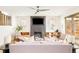 Bright living room featuring a stacked stone fireplace with TV and a ceiling fan at 2658 Wolff St, Denver, CO 80212