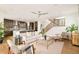 Open-concept living room with modern furnishings, wood floors, and seamless flow to the kitchen at 2658 Wolff St, Denver, CO 80212