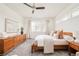 Comfortable bedroom showcasing natural light from large windows and a wooden dresser at 2658 Wolff St, Denver, CO 80212