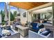 Covered patio with a gas fire pit, plush seating, and seamless indoor/outdoor living at 2658 Wolff St, Denver, CO 80212