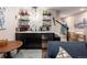 A modern bar area equipped with open shelving, black cabinets, and sleek countertops at 3472 Harvard Pl, Broomfield, CO 80023
